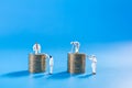 Business, Money, Planning and Saving Concept. Close up of group of worker cleaning and painting stack of gold coin on blue