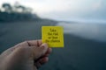 Business motivational inspirational quote - Take the risk or lose the chance. With person holding yellow card in hand. Royalty Free Stock Photo