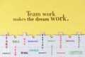 Business motivational quote - Team work makes the dream work. On yellow background of white jig saw puzzle missing pieces. Royalty Free Stock Photo