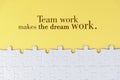 Business motivational quote - Team work makes the dream work. On yellow background of white jig saw puzzle missing pieces. Royalty Free Stock Photo