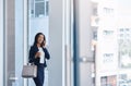 Business moves to the pace that she does. a young businesswoman talking on a cellphone in an office.