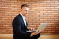 Business man using laptop at home while sitting on floor Royalty Free Stock Photo