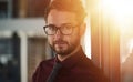 Business is my business. Portrait of a confident young businessman standing in a modern office. Royalty Free Stock Photo