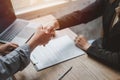 Business negotiations real estate agents women shaking hands with clients after signing property sales contracts.