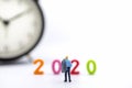 Business and 2020 New Year Planning Concpet. Close up of businessman miniature figure people with jacket standing on white Royalty Free Stock Photo