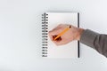 business notepad, hand holding a pencil on a white background