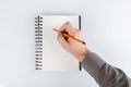 business notepad, hand holding a pencil on a white background