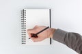 business notepad, hand holding a pencil on a white background