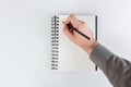 business notepad, hand holding a pencil on a white background