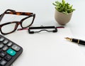 Business objects, clipboard with blank sheet of paper, pen, glasses and calculator on white background Royalty Free Stock Photo