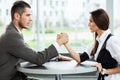 Business and office concept - businesswoman and businessman arm wrestling during meeting in office. Royalty Free Stock Photo