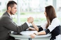 Business and office concept - businesswoman and businessman arm wrestling during meeting in office. Royalty Free Stock Photo