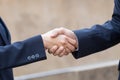 Close up businessman shaking hands each other