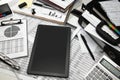 Business office desk closeup - blank screen of tablet computer, financial reports, analysis and accounting, set of documents for Royalty Free Stock Photo
