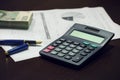 Business office desk with pen calculator charts and money Royalty Free Stock Photo