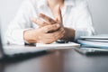 A business office worker is an asian woman is sitting in front of the laptop computer. A businesswoman stressing her body part Royalty Free Stock Photo