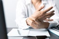 A business office worker is an asian woman is sitting in front of the laptop computer. A businesswoman stressing her body part Royalty Free Stock Photo