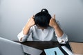 A business office worker is an asian woman is sitting in front of the laptop computer. A businesswoman stressing her body part Royalty Free Stock Photo