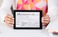 Business official showing income tax form 1040 in a tablet Royalty Free Stock Photo