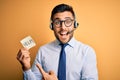 Business operator man with customer service headset from call center offering help and support very happy pointing with hand and Royalty Free Stock Photo