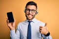 Business operator man with customer service headset from call center showing smartphone screen happy with big smile doing ok sign, Royalty Free Stock Photo