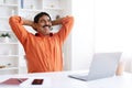 Cheerful dreamy mature indian man sitting at home office Royalty Free Stock Photo