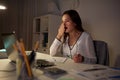 Tired woman with papers yawning at night office Royalty Free Stock Photo