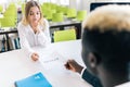 Business owner boss advisor interviewing new candidate young woman vacancy company sitting at the desk in office. Boss smiling