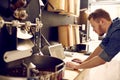 Business owner of a coffee roastery checking his laptop Royalty Free Stock Photo