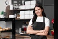 Business owner near showcases with desserts in her cafe Royalty Free Stock Photo