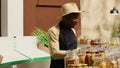 Business owner restocking crates of fresh fruits and vegetables