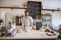 Business owner standing behind the counter at a coffee shop Royalty Free Stock Photo
