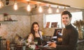 Business owner using laptop working with laptop at the bar of the modern cafe. Royalty Free Stock Photo