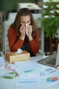 business owner woman blowing nose and working with documents Royalty Free Stock Photo