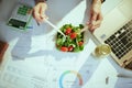 business owner woman in green office eating salad Royalty Free Stock Photo