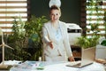 business owner woman in green office giving hand for handshake Royalty Free Stock Photo