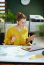 business owner woman in green office having web cam meeting Royalty Free Stock Photo