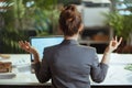 business owner woman in grey business suit at work meditating Royalty Free Stock Photo