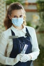 Business owner woman with mask, gloves, hair comb and scissors Royalty Free Stock Photo