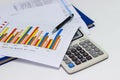 Business paper graphs and pen with charts report, calculator on desk of financial planning Royalty Free Stock Photo