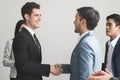 Business partner agreement success concept.Two businessmen shaking hands after seal a deal in the meeting and their staff team Royalty Free Stock Photo