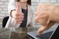 Business Partner Showing Thumbs Up And Thumbs Down Royalty Free Stock Photo