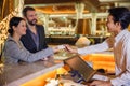 Business partners or colleagues doing check in at the hotel. Young couple and receptionist at counter in hotel