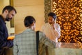Business partners or colleagues doing check in at the hotel. Young couple and receptionist at counter in hotel