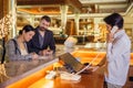 Business partners or colleagues doing check in at the hotel. Young couple and receptionist at counter in hotel