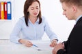 Business partners discussing documents and strategic planing at meeting. Office background. Businesswoman and Businessman.