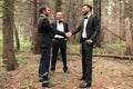 Business partners greeting each other with handshakes at a meeting in the woods