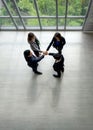 Business partners join hands in the modern office. Standing near the window in the hallway