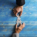 Business partners matching two puzzle pieces in a conceptual image of a merger Royalty Free Stock Photo