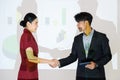 Business partners shaking hands after concluding a business presentation finished. Business man and woman standing in front of Royalty Free Stock Photo